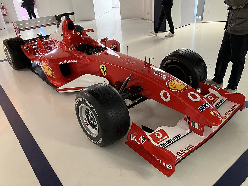 A close-up photo of a Ferrari F2003-GA car on display at an exhibition