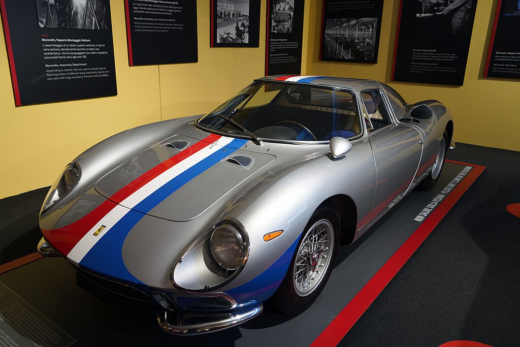A close-up photo of a Ferrari 250 LM car on display at an exhibition