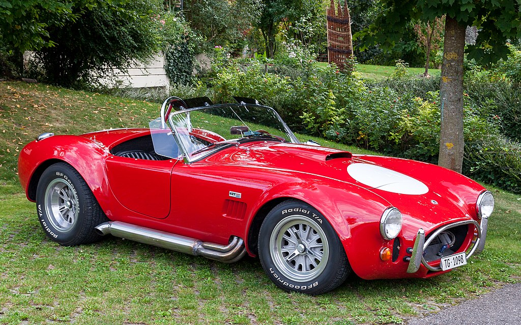 A close-up photo of a AC Cobra car on display at an exhibition