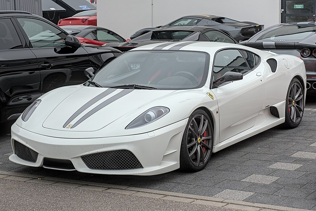 A close-up photo of a Ferrari F430 Scuderia car on display at an exhibition