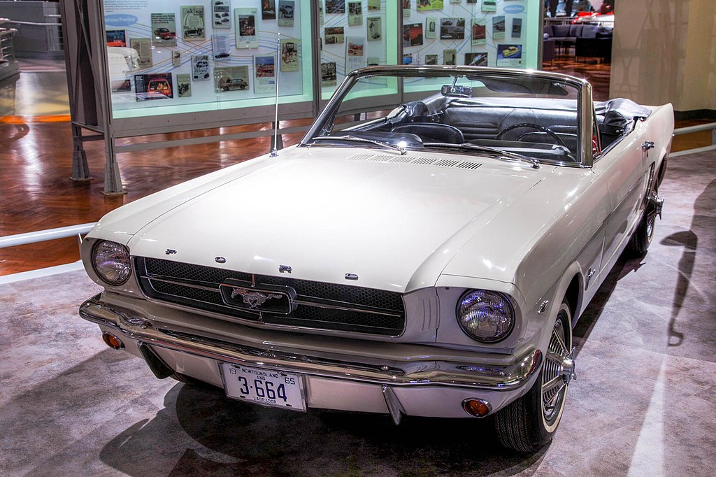A close-up photo of a Ford Mustang car on display at an exhibition