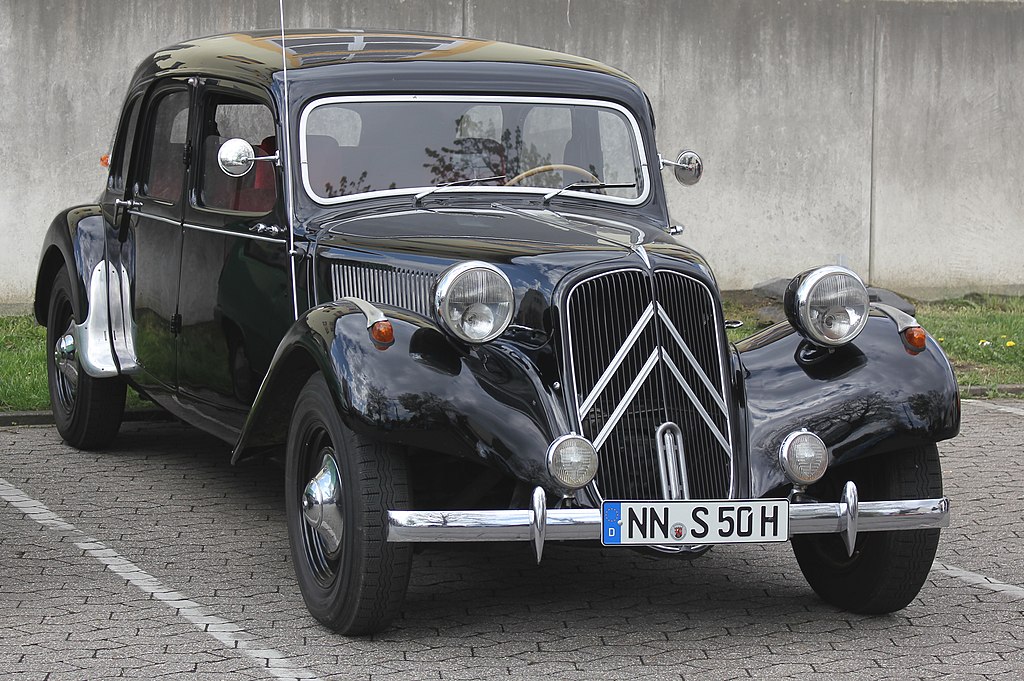 A close-up photo of a Citroën Traction Avant car on display at an exhibition