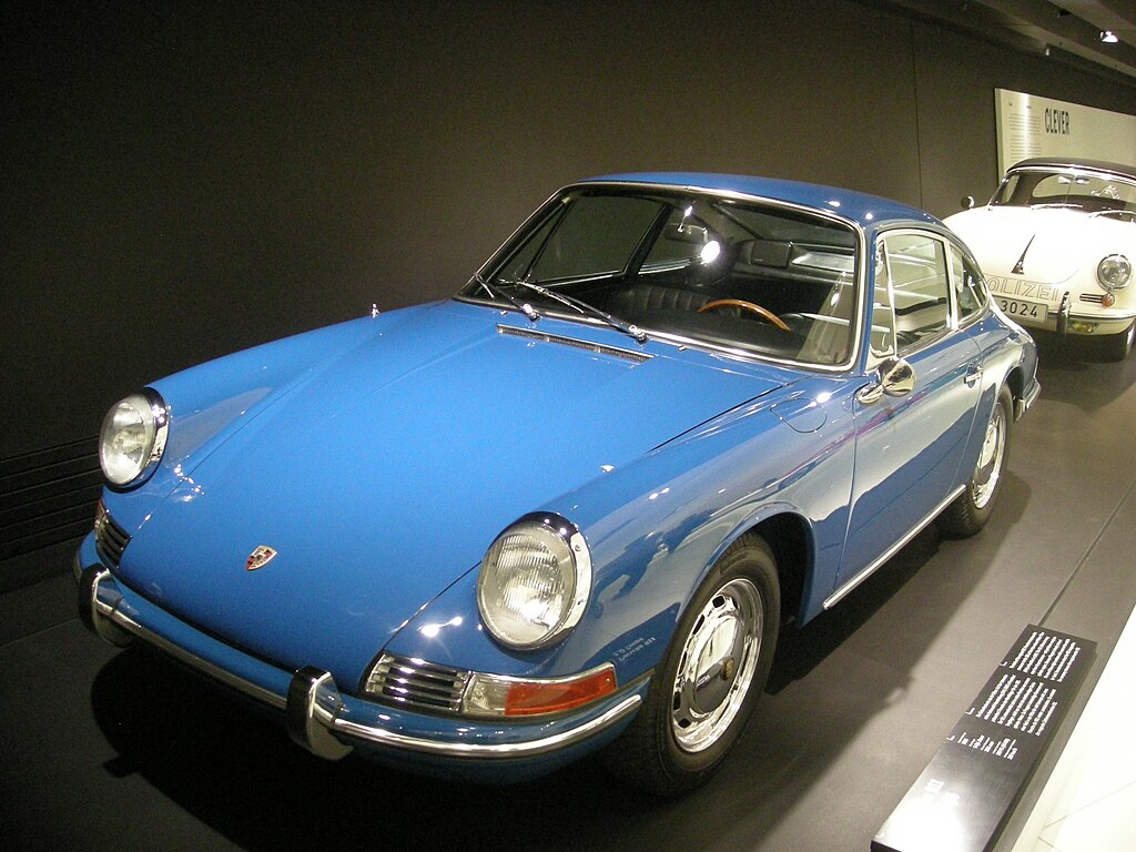 A close-up photo of a Porsche 911 car on display at an exhibition