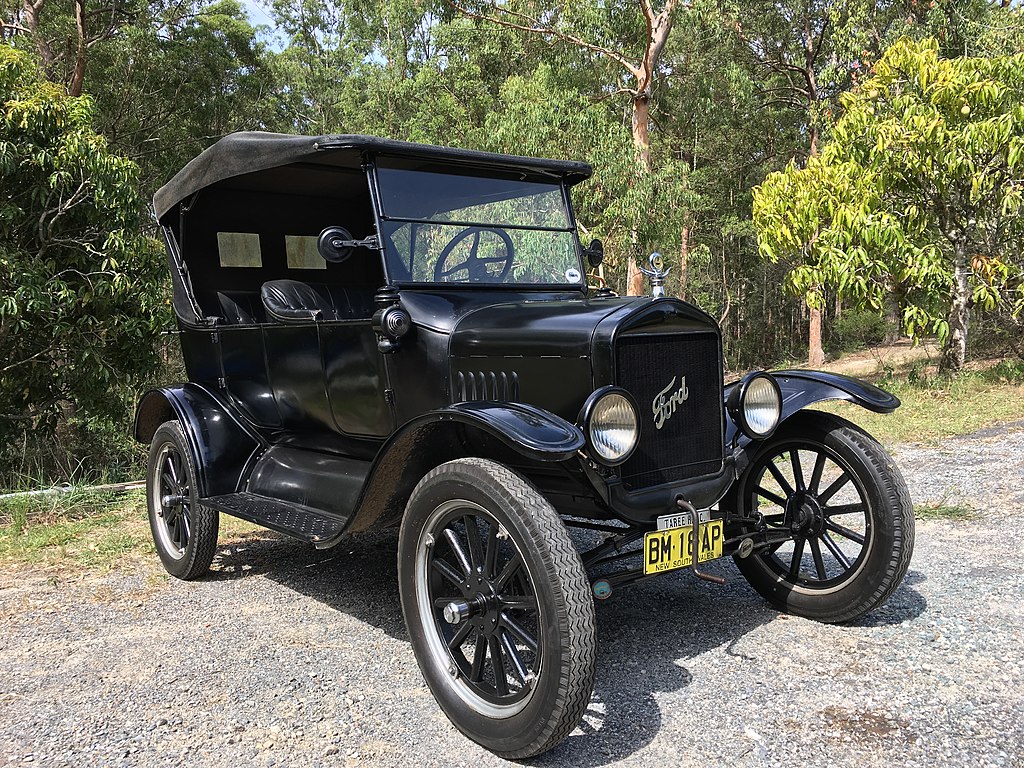 A close-up photo of a Ford Model T car on display at an exhibition