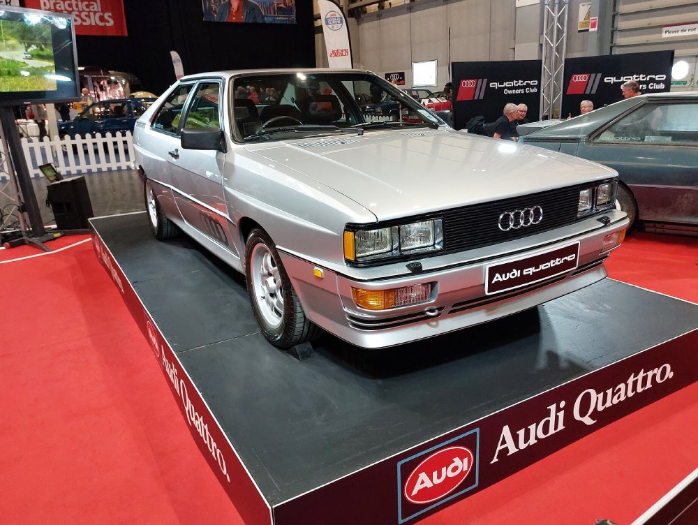 A close-up photo of a Audi Quattro car on display at an exhibition