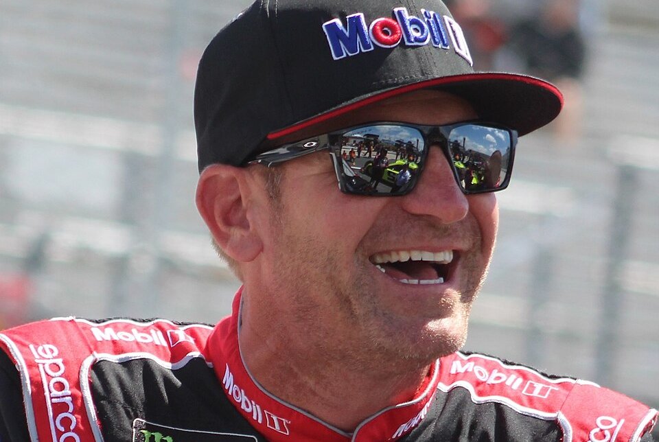 Clint Bowyer wearing a black cap and a pair of sunglasses