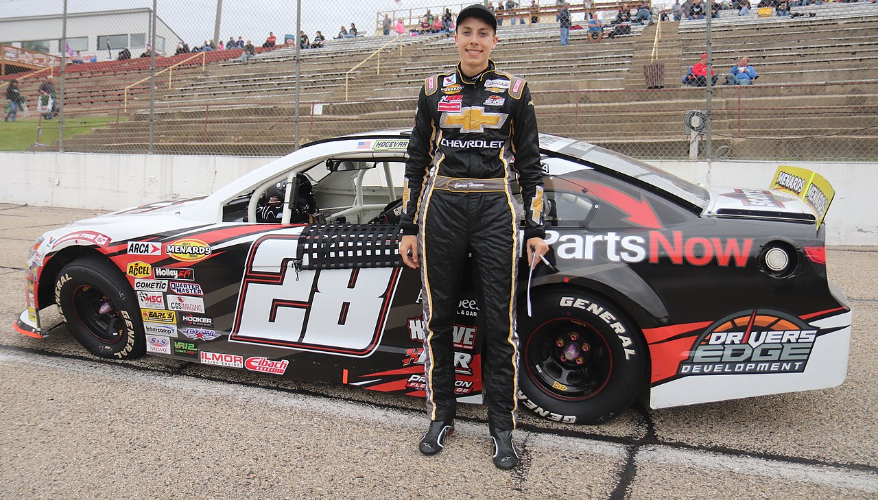 Carson Hocevar beside his #28 Chevrolet SS ARCA car at Madison International Speedway.