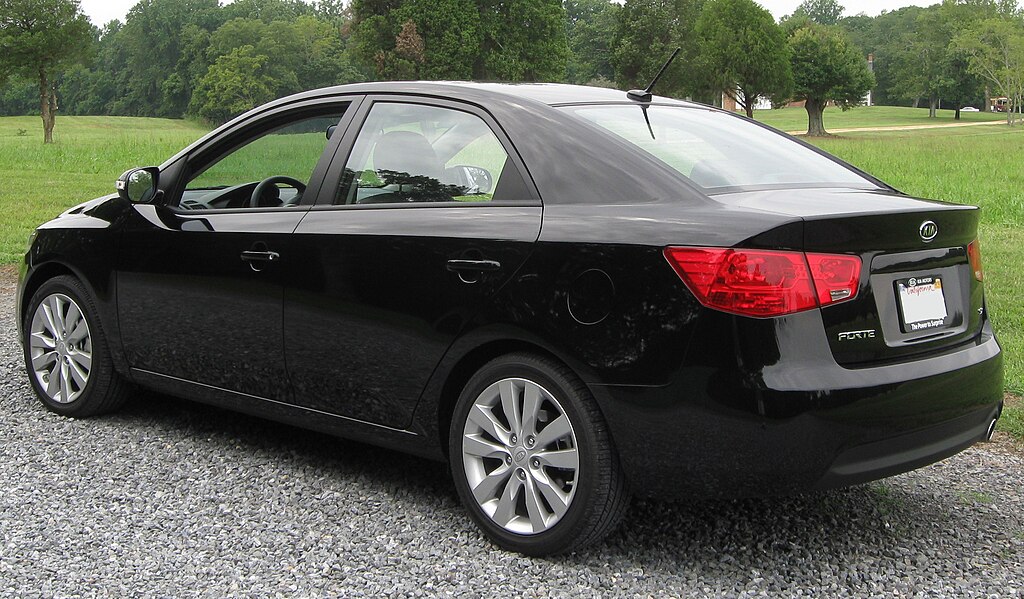 A close-up photo of a Kia Forte car parked in a parking lot