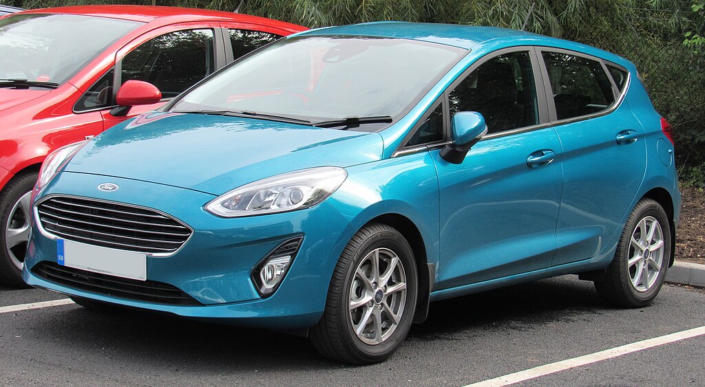 A close-up photo of a Ford Fiesta car parked in a parking lot