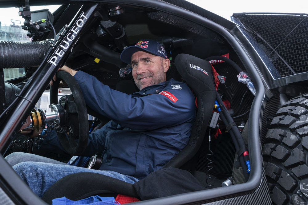 Racer, champion of the Dakar, driver Stephane Peterhansel from Peugeot team