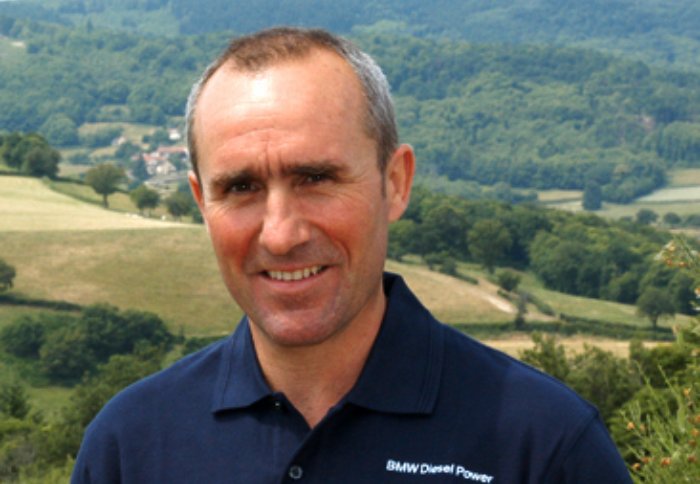 Stephane Peterhansel wearing blue shirt and smiling at the camera
