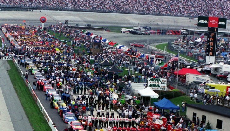 Drivers and their crews line up for the national anthem