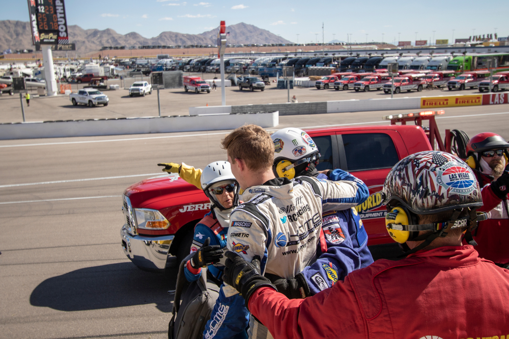 Matt Tift  is helped out of his car after an accident off turn four at the track