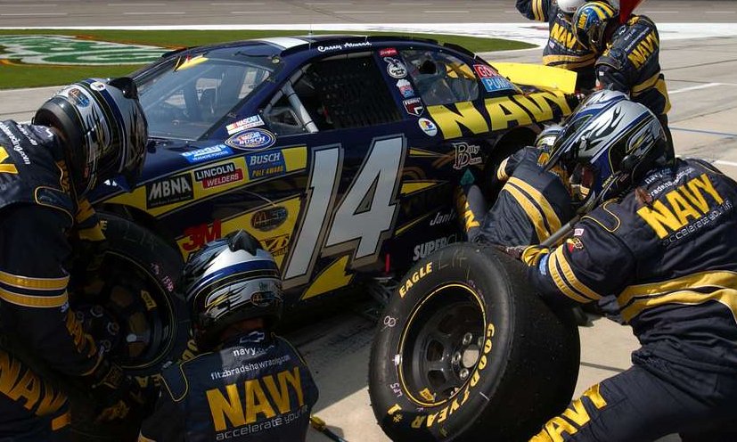 The Navy sponsored Fitz-Bradshaw pit crew performs a flawless pit stop