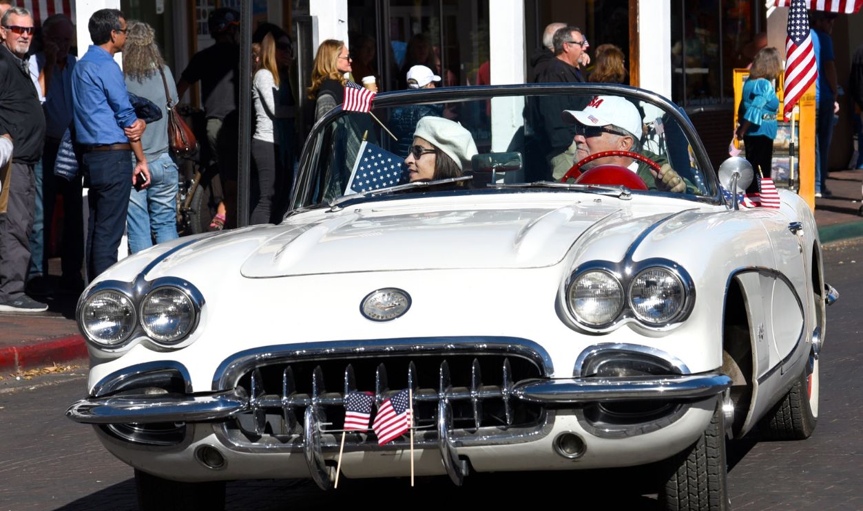 SANTA FE, NM - NOVEMBER 11, 2017: A couple in a 1958 Corvette convertible participate in a Veterans Day parade in Santa Fe, New Mexico. 