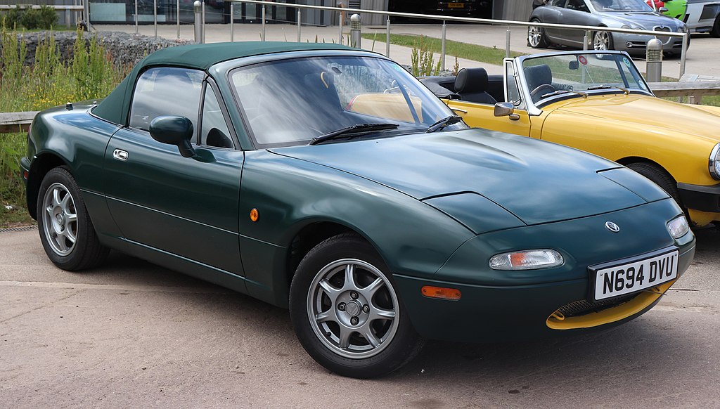 A close-up photo of a Mazda Miata car parked in a parking lot
