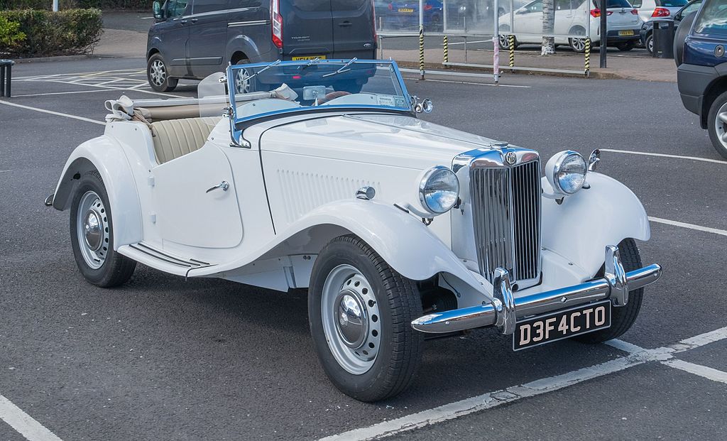 A close-up photo of a MG TD car parked in a parking lot