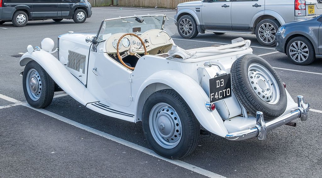 A close-up photo of a MG TD car parked in a parking lot