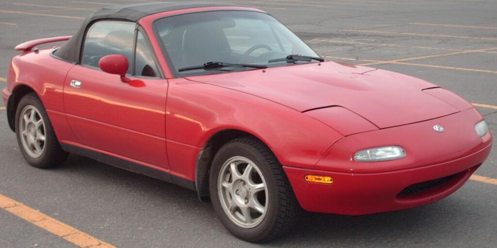 A close-up photo of a Mazda Miata car parked in a parking lot