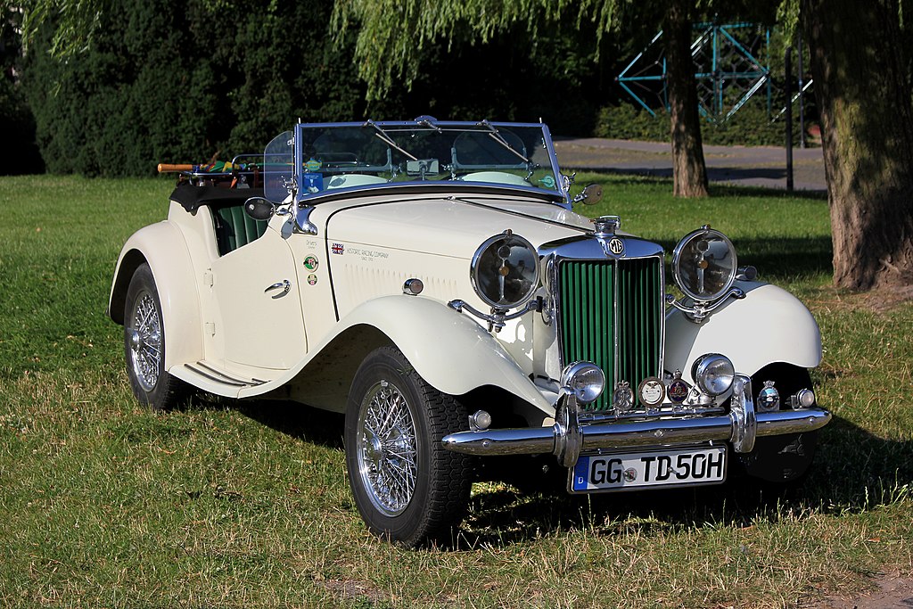 A close-up photo of a MG TD car parked in a parking lot