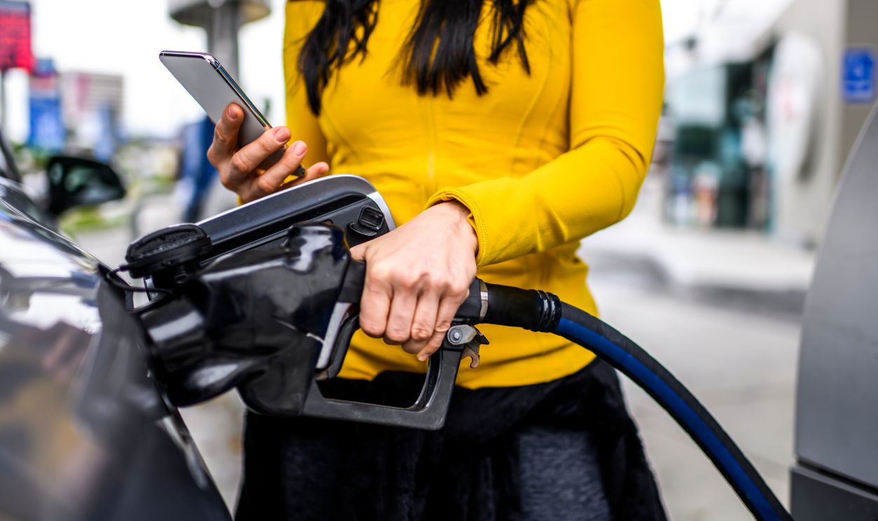 Filling a car with gas at a station