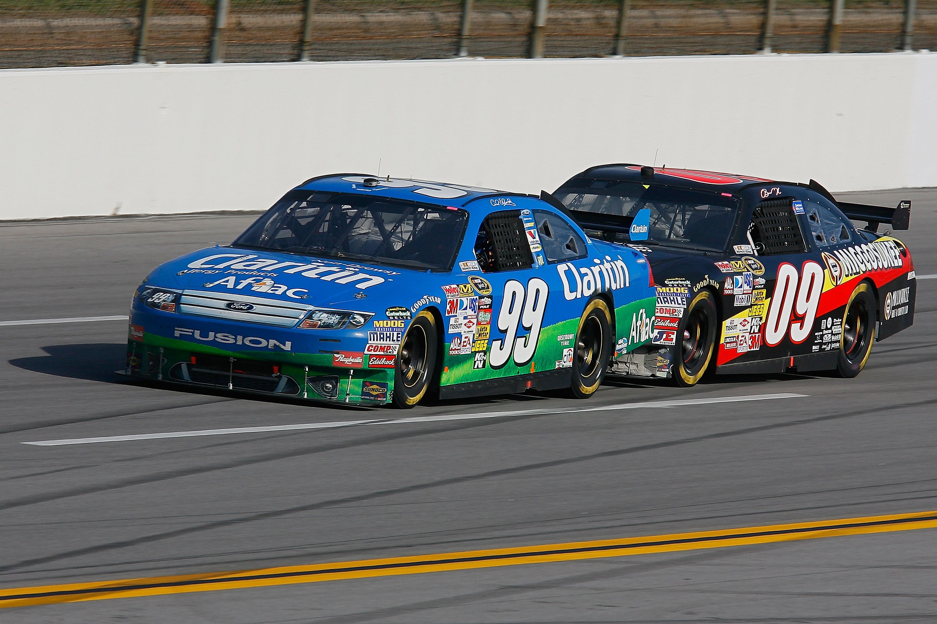 Carl Edwards, driver of the #99 Claritin Ford and Brad Keselowski, driver of the #09 Miccosukee Chevrolet