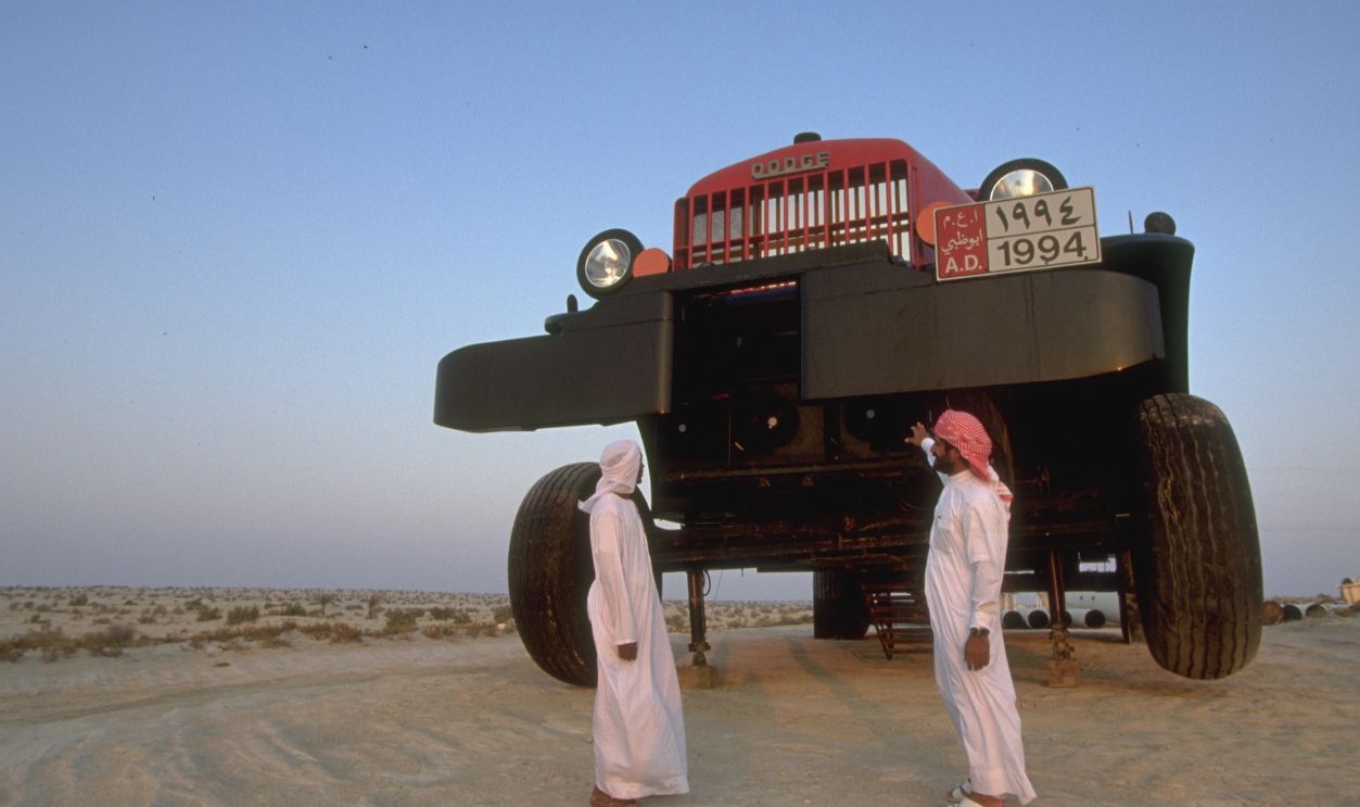 The Sheikh in front of the world's biggest lorry in which he transports his globe-shaped caravan