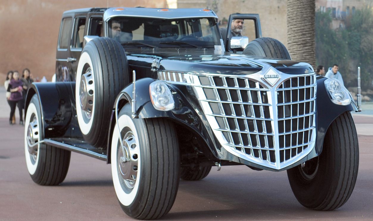 A man and his children look on as a member of the Abu Dhabi royal family in the United Arab Emirates (UAE), Sheikh Hamad bin Hamdan al-Nahyan (R), 55, climbs into his own concept car dubbed the 