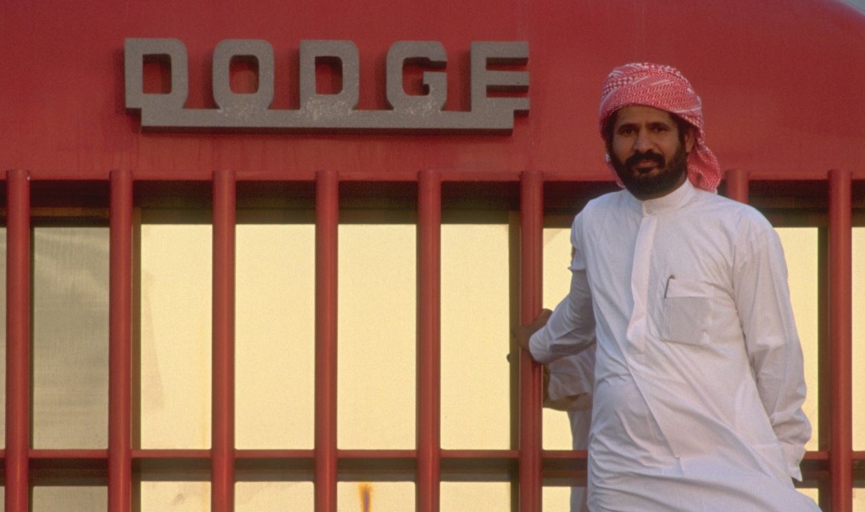 The Sheikh in front of the world's biggest lorry in which he transports his globe-shaped caravan