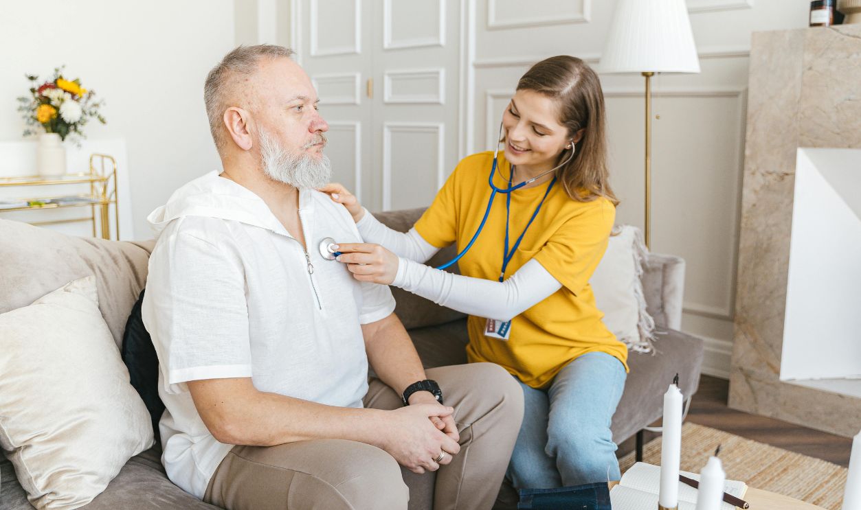 A woman in yellow shirt using a stethoscope 