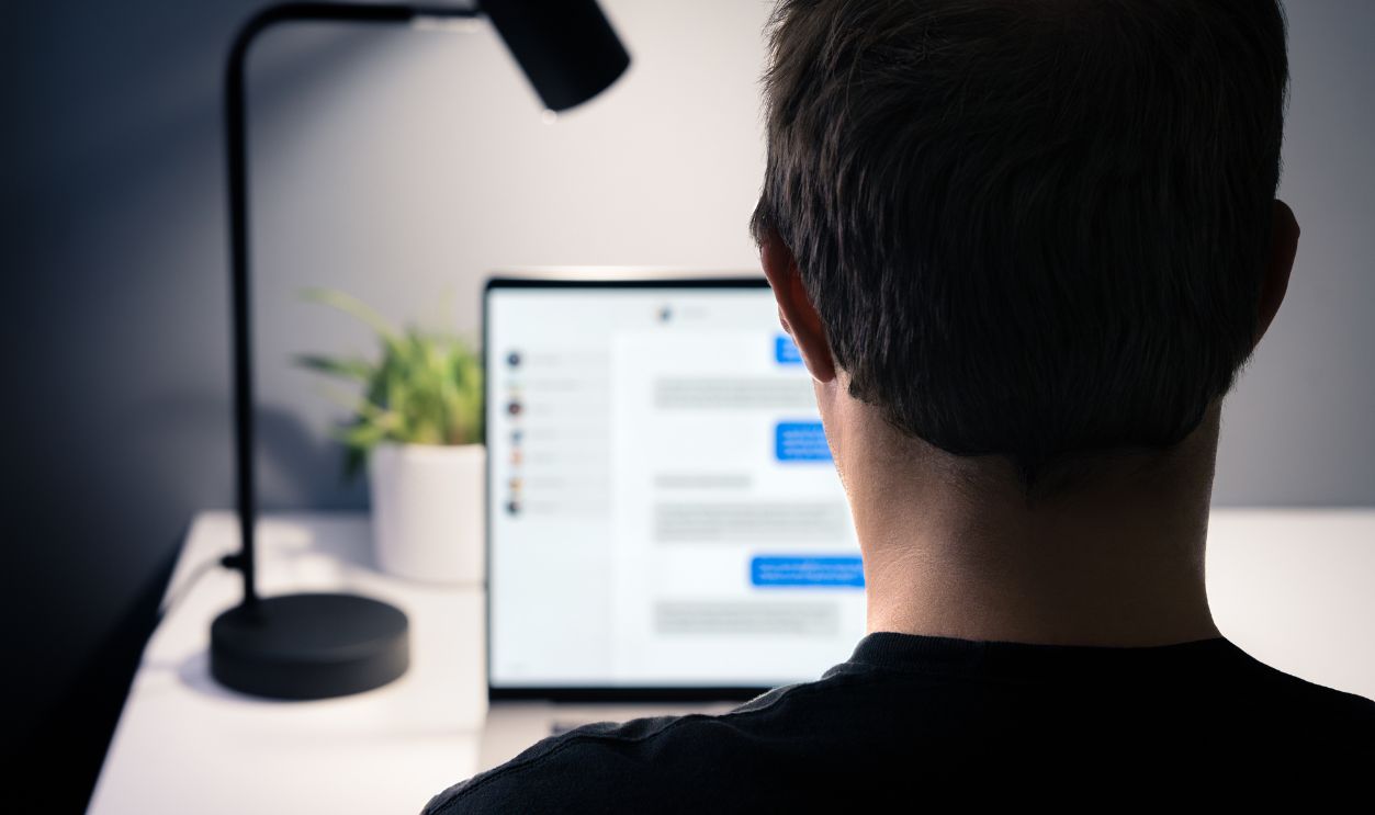 Love scam and romance fraud with messages. Online chat catfish with fake identity. Infidelity, cheating husband with secret relationship. Fraudster, swindler, scammer or cheater with laptop computer.