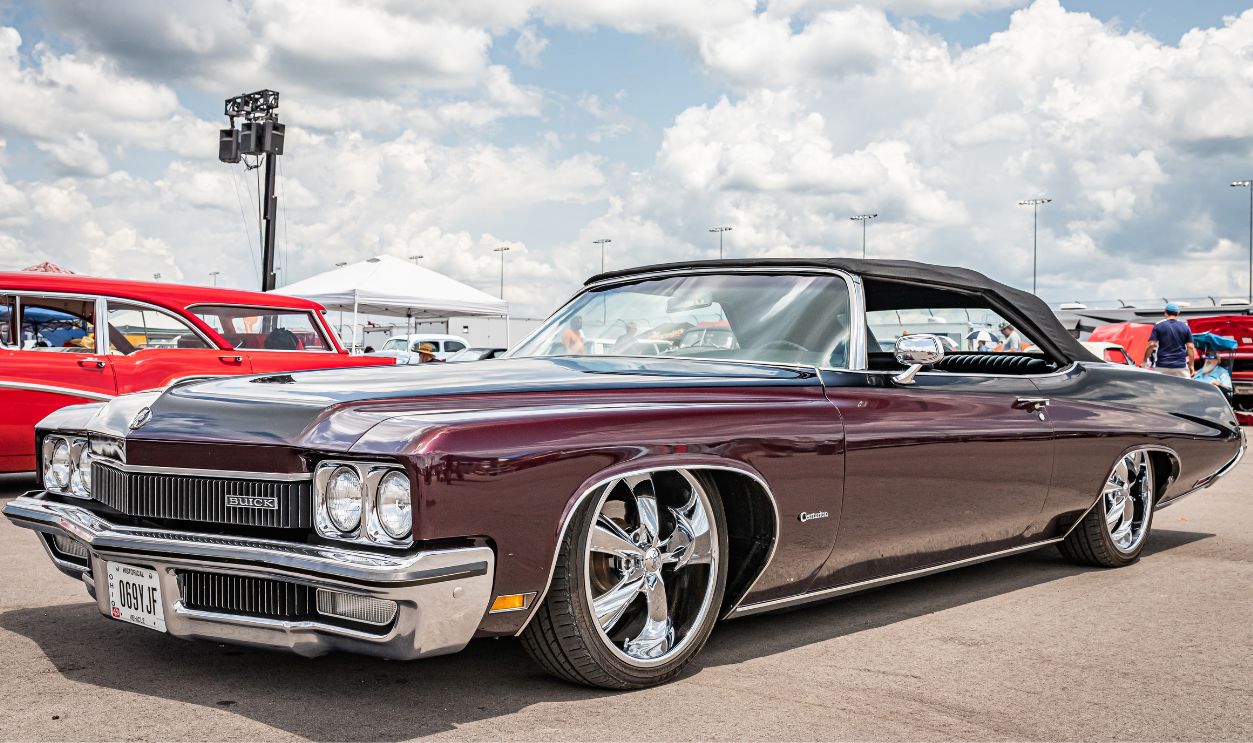  Low perspective front corner view of a 1972 Buick Centurion Convertible at a local car show.