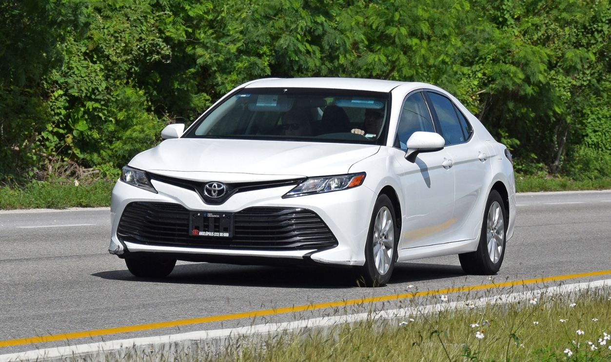 Modern Toyota Camry driving on the road. The eight generation of Toyota Camry was debut in 2017. This model is one of the most popular Toyota vehicles in North America.