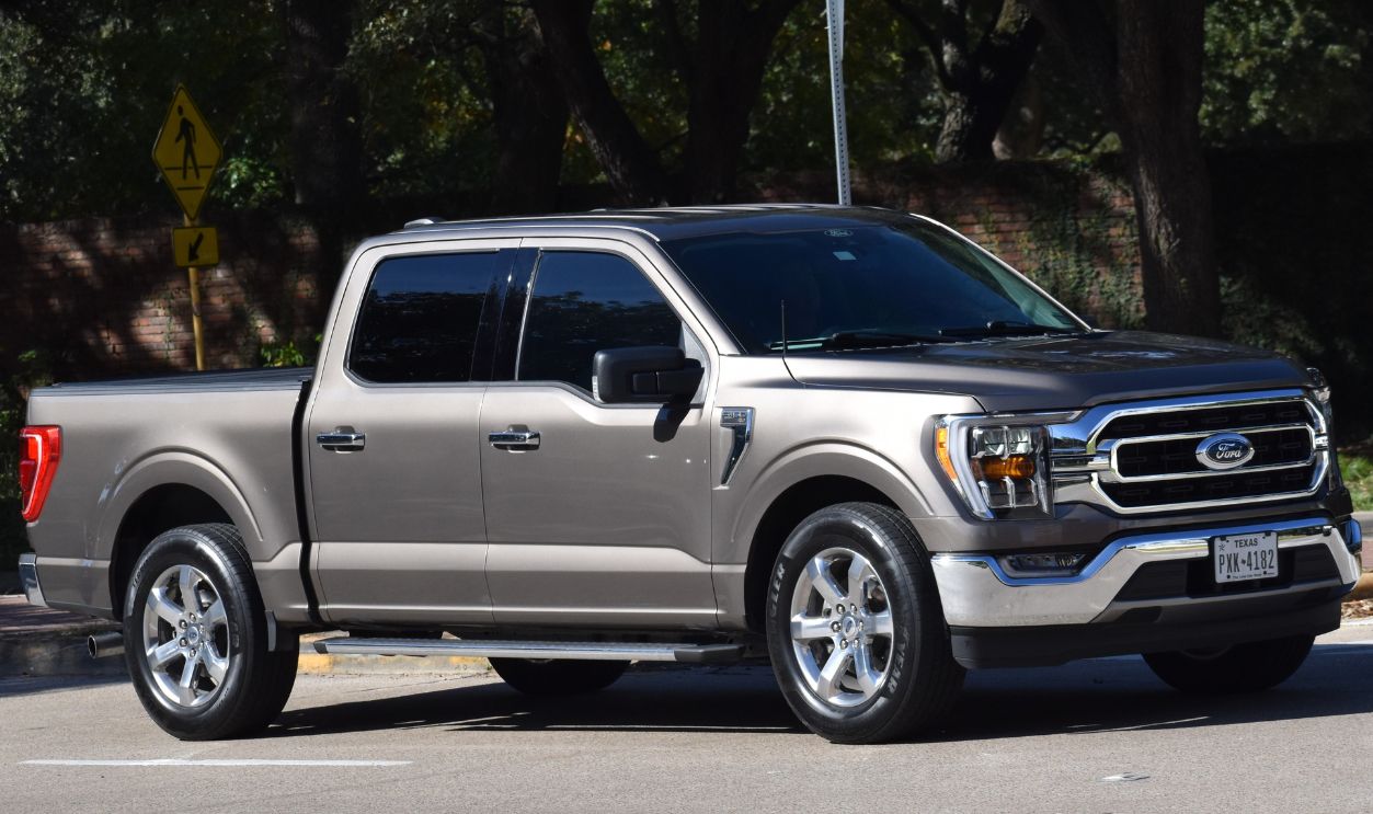  A portrait of a new tan Ford F150 pick-up truck near Hermann Park, Houston TX