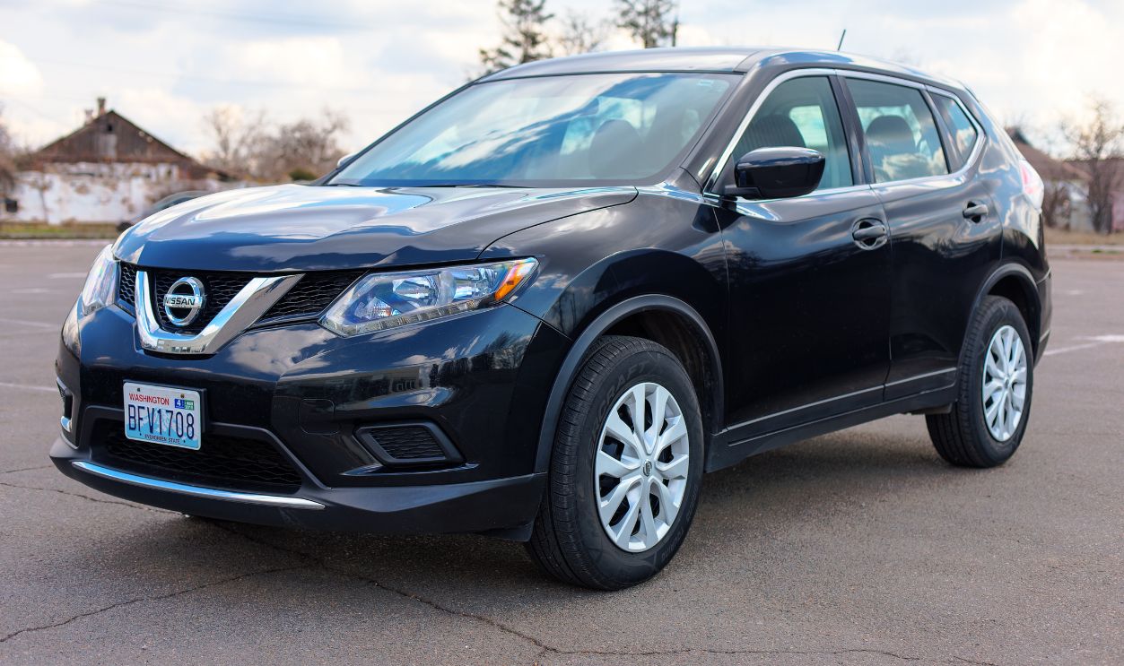 Photo of black Nissan Rogue in the open air.
