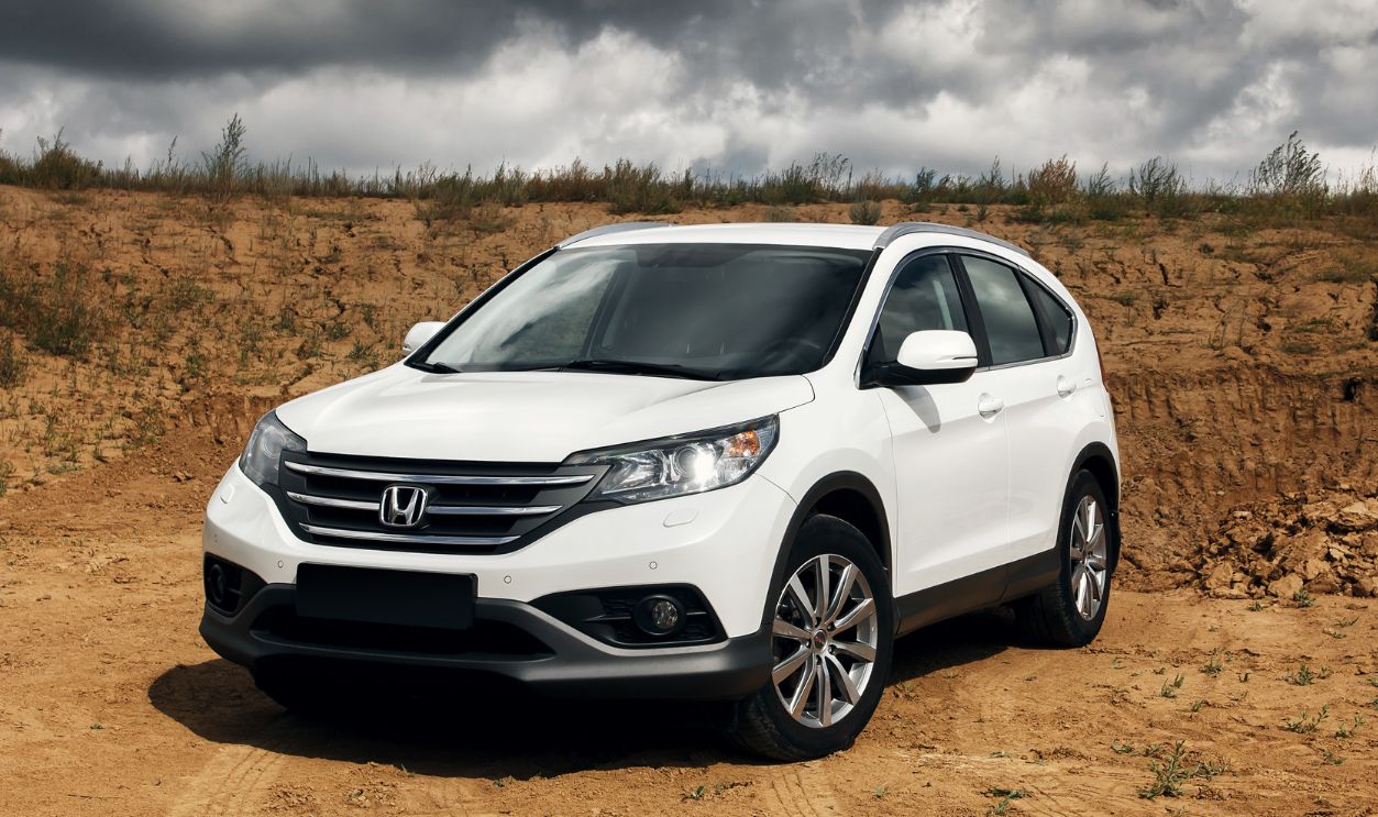 White car Honda CR-V (RM) is parked at countryside road at the daytime