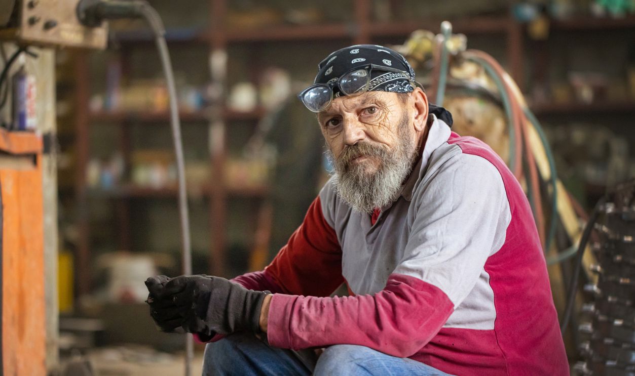 An Old Man In Garage