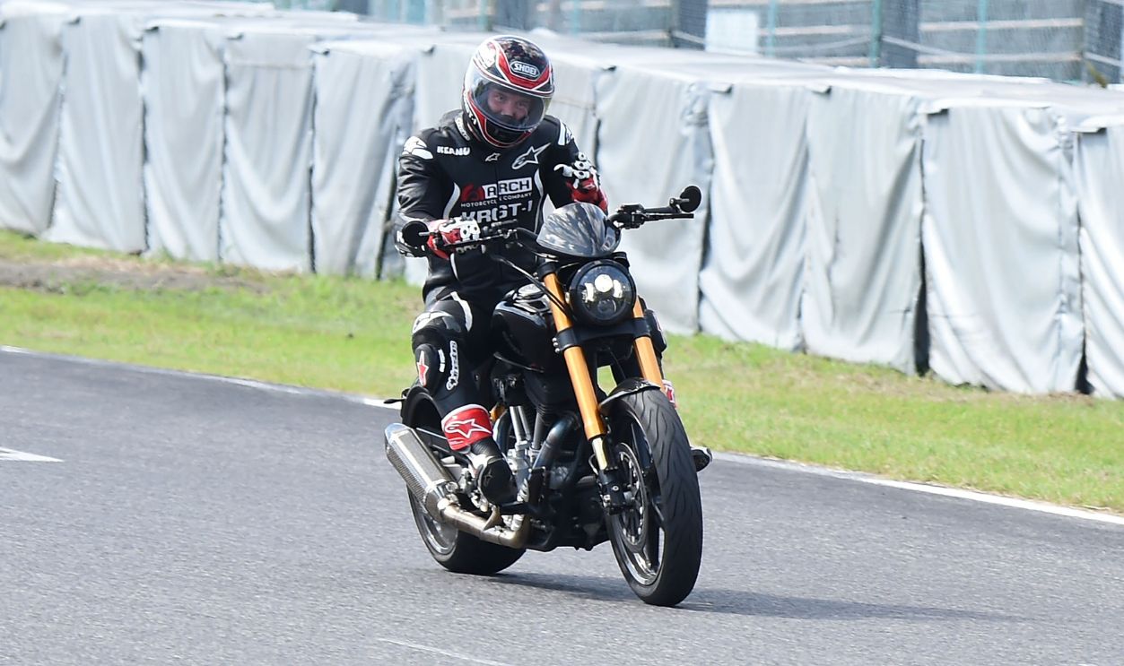 Keanu Reeves test-rides his Arch Motorcycle during the Suzuka 8 Hours at the Suzuka Circuit on July 25, 2015 in Suzuka, Japan.