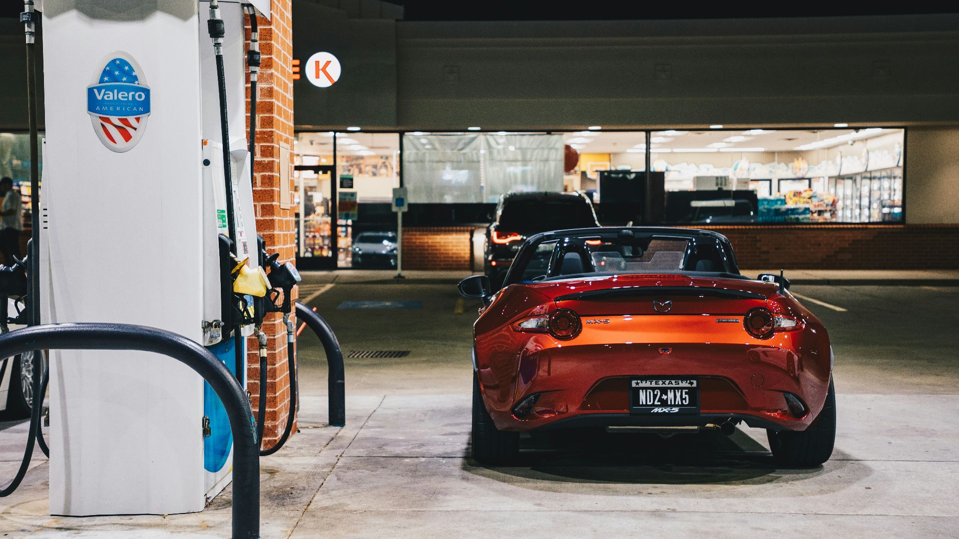 A sports car refueling at a gas station.