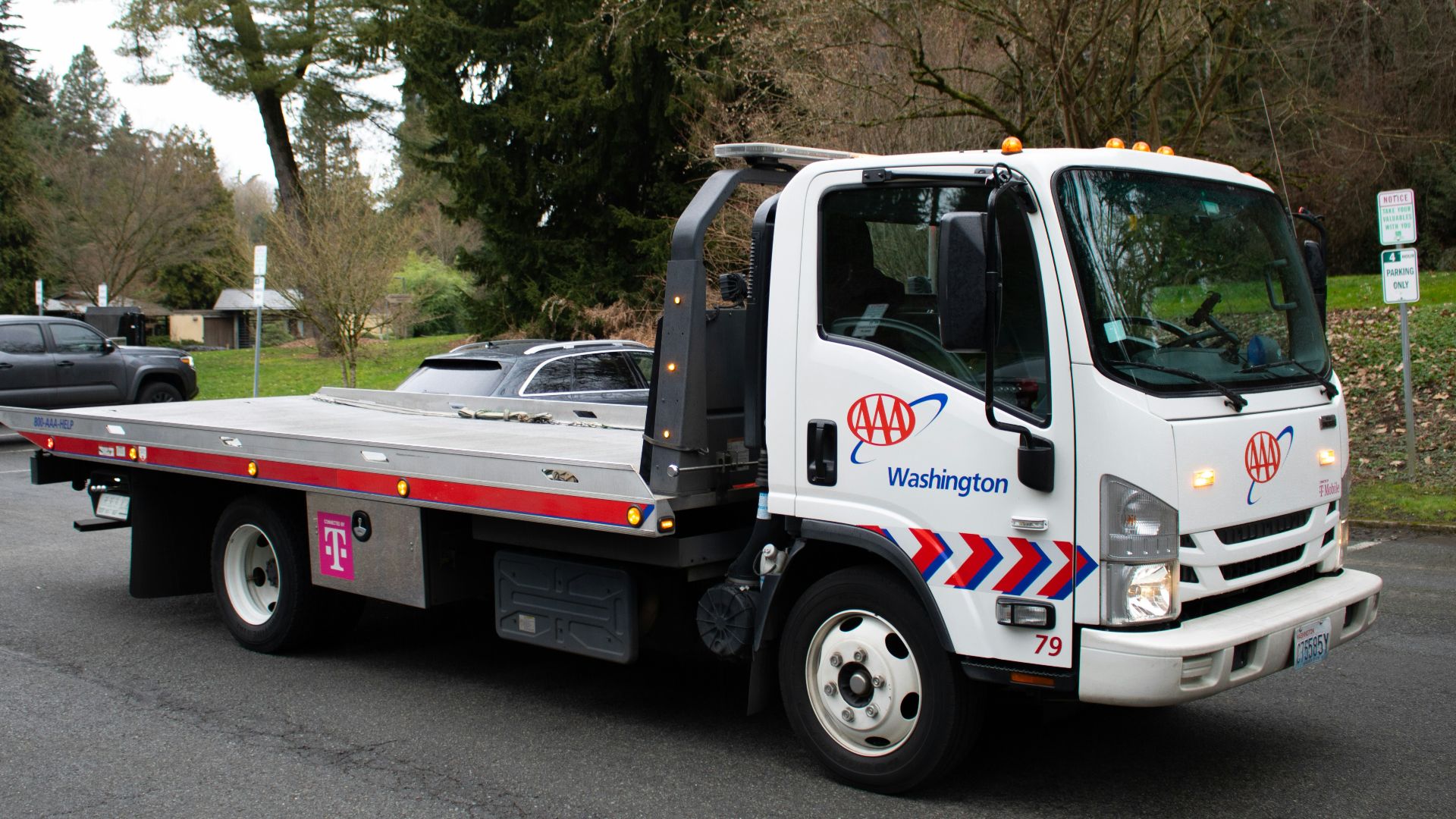 A tow truck is driving on a street.