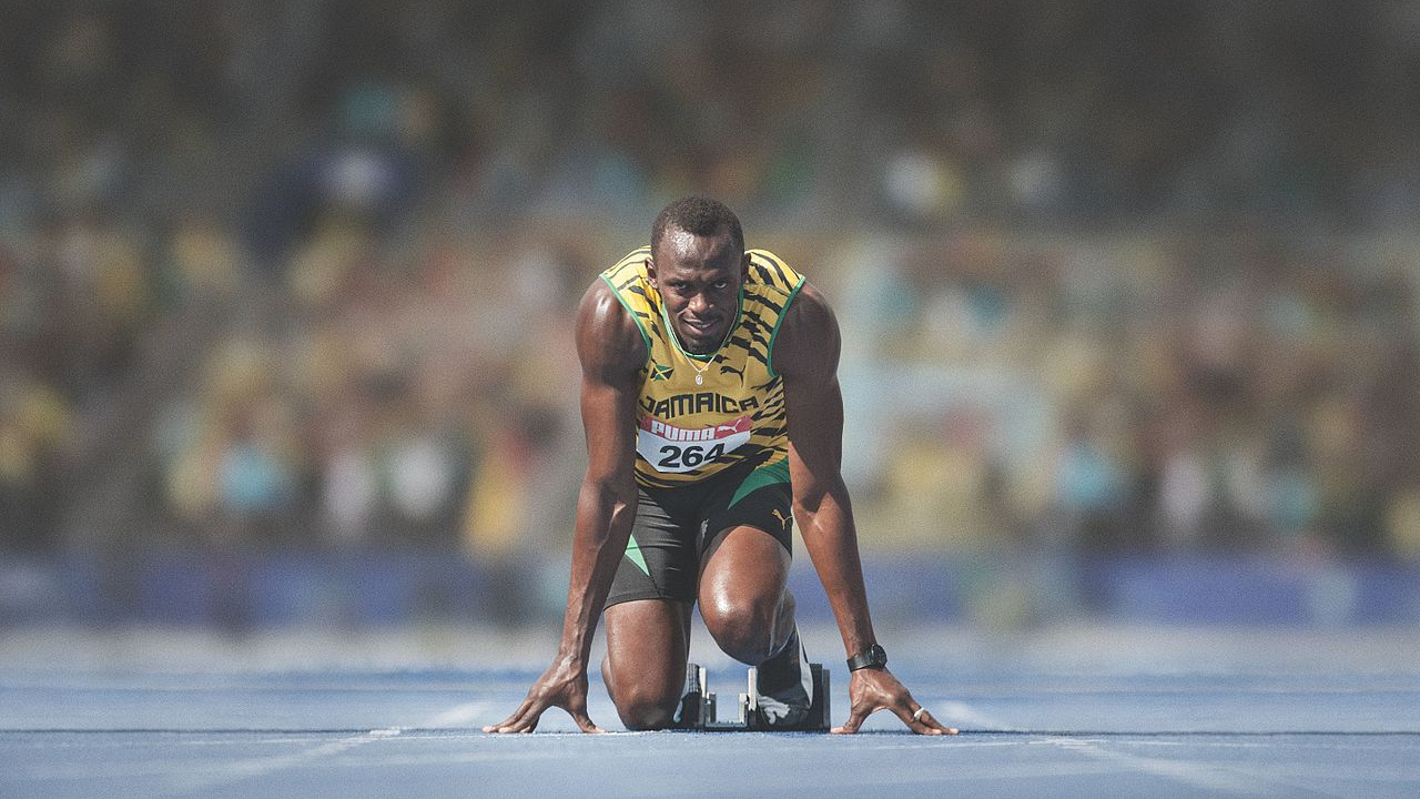 Usain Bolt at the start of a race in 2014