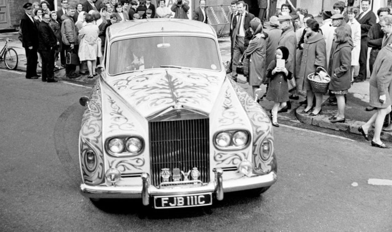 John Lennon's refurbished Rolls, a ø6,000 1965 Phantom V, is now a shrieking yellow, with zodiac sig on the roof and scrolls and flowers in a kaleidoscope of colour all over, Being delivered to John's house, the paint job was done by James Fallon, who's company performed the ø1,000 operation in Chertsey, Surrey.