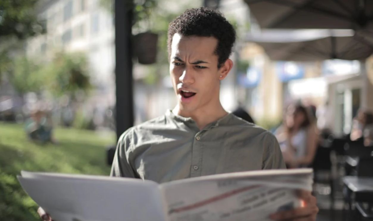 Surprised News paper reader