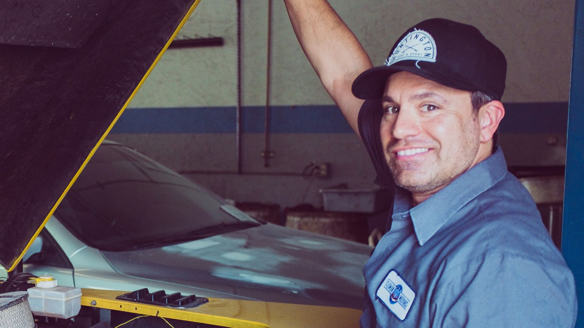 man holding open-wide car trunk