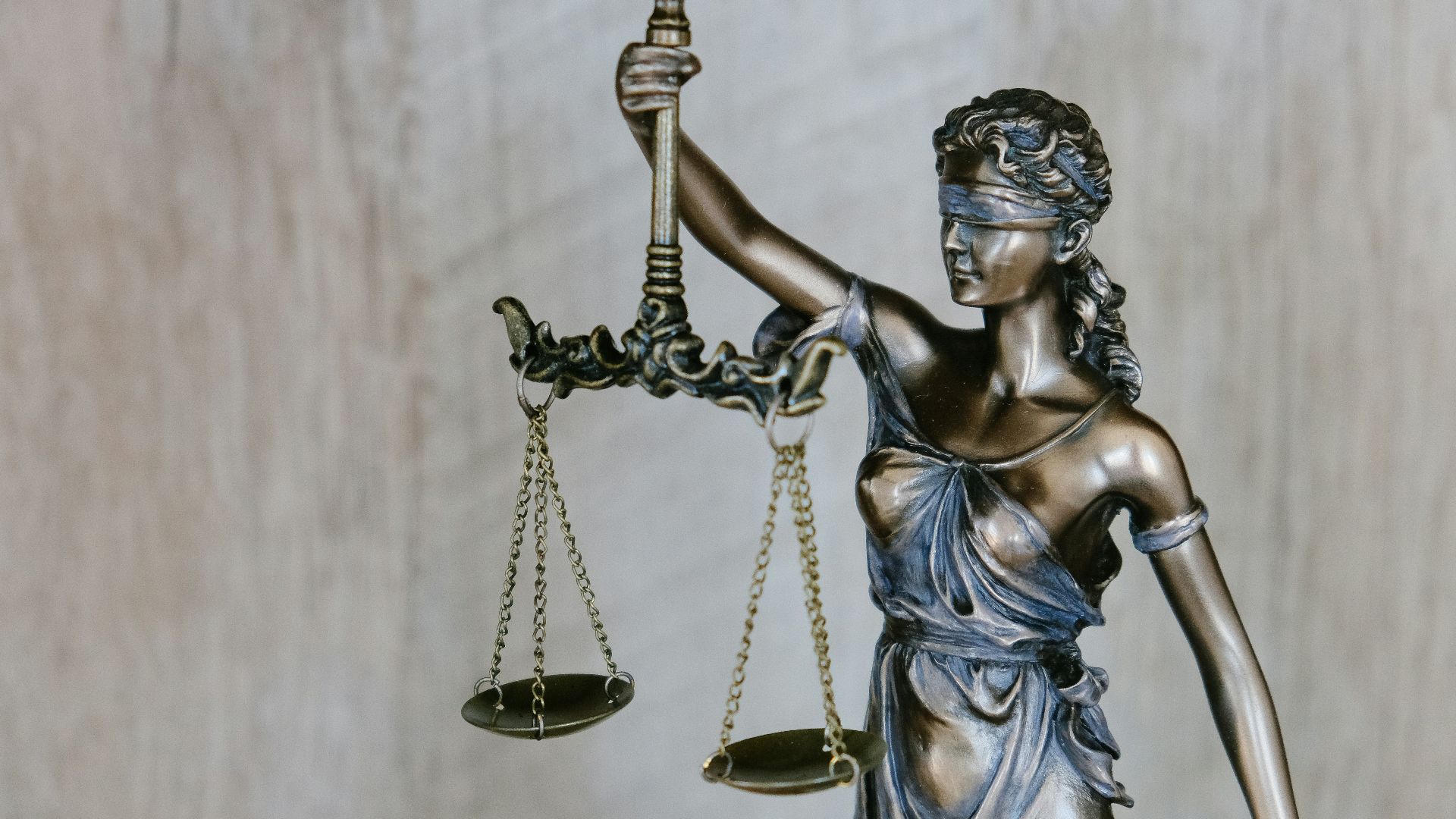 woman holding sword statue during daytime