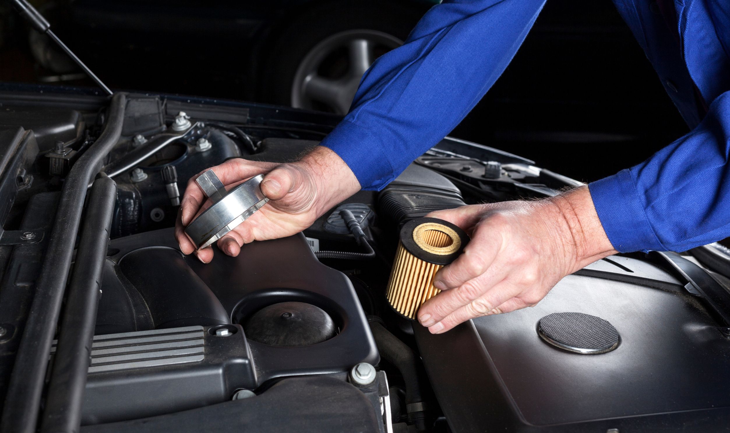 Mechanic is preparing an oilfilter change at a modern car engine