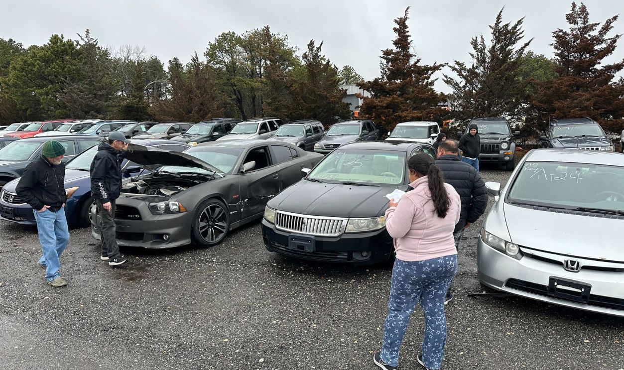 People attend a preview of cars on March 7, 2024, that will be auctioned off at the Suffolk County Police Impound yard in Westhampton, New York. 