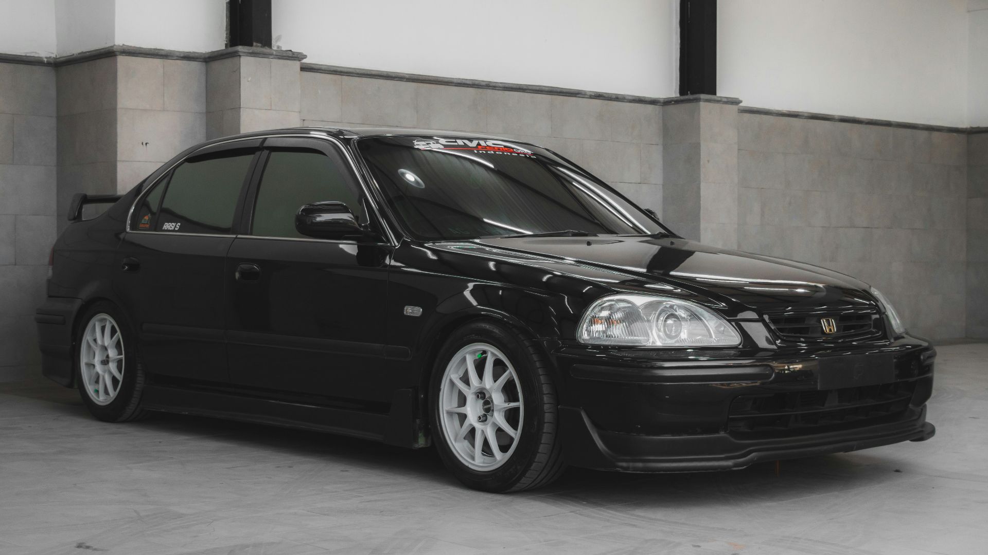 a black car parked in a parking garage