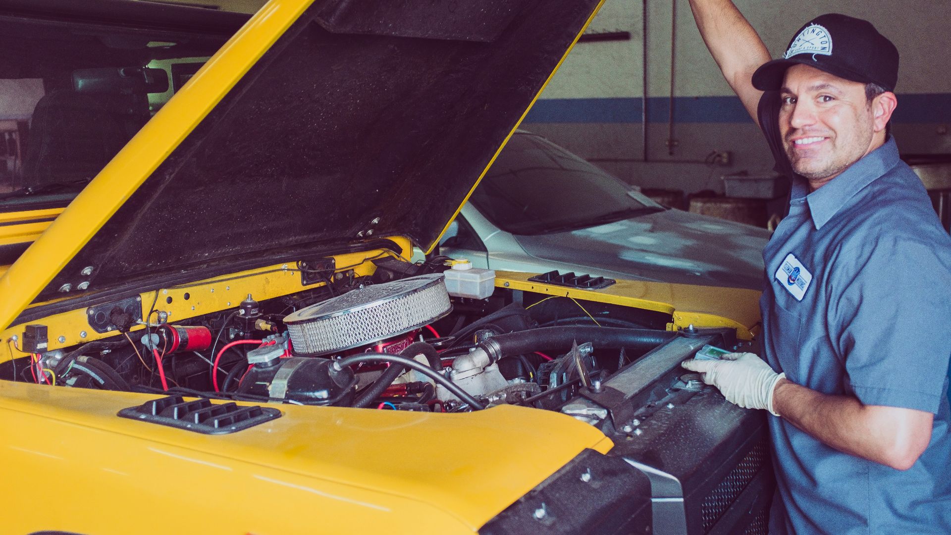 man holding open-wide car trunk