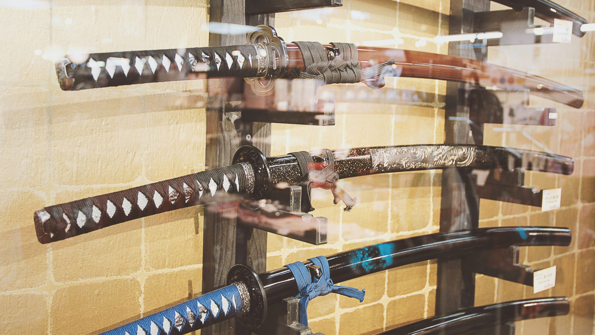 a display of different types of knives in a glass case